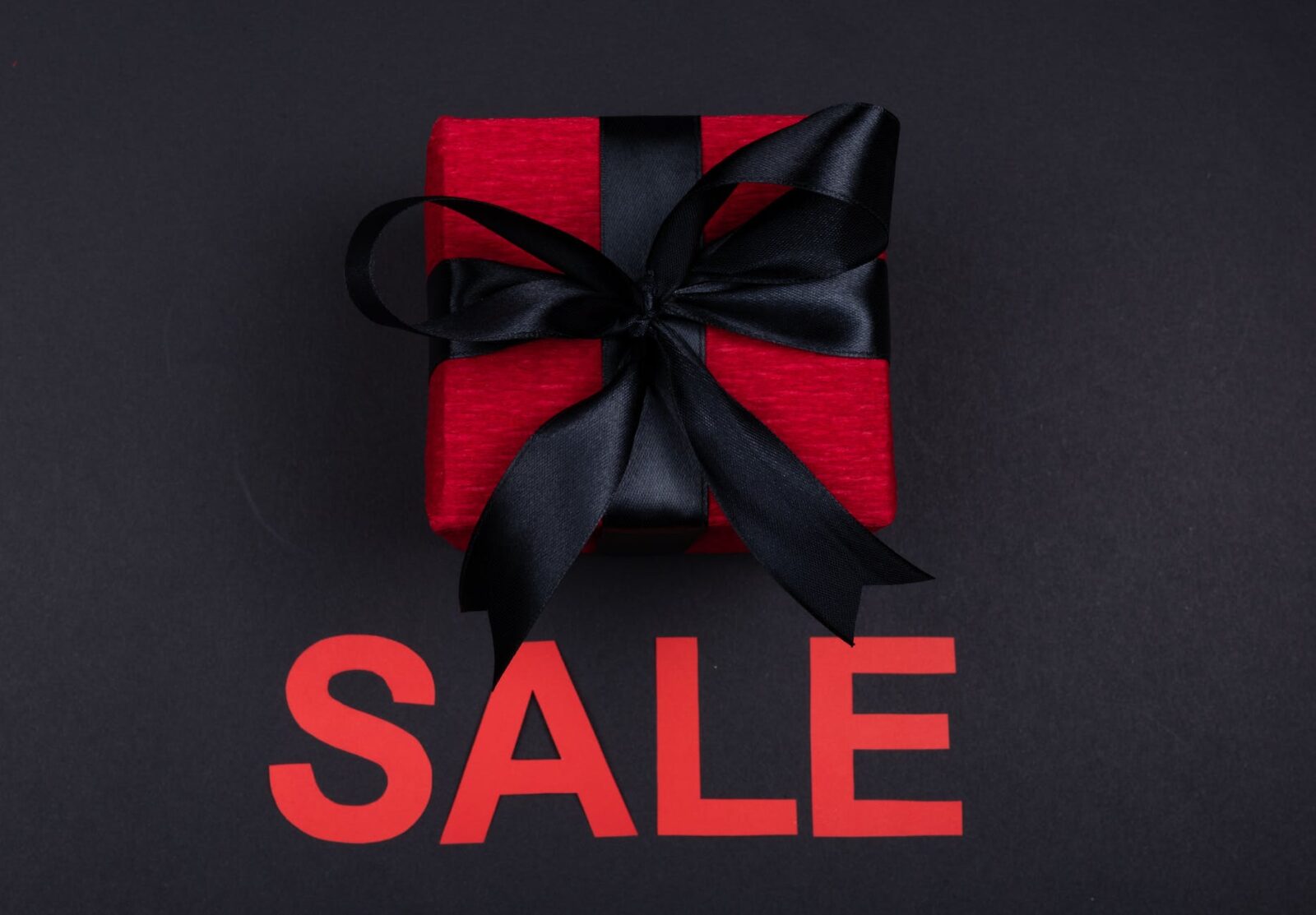 red gift box with black ribbon